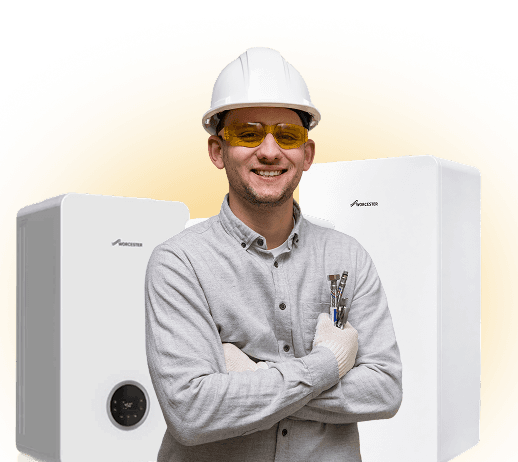 Heating engineer standing in front of boilers
